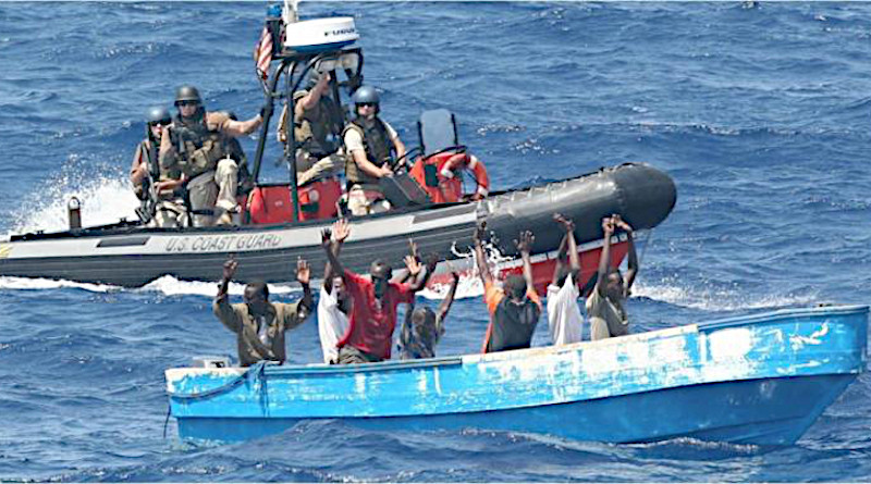 Suspected pirates surrender to a US Coast Guard patrol boat in waters near the Strait of Hormuz. CREDIT U.S. Coast Guard/LCDR Tyson Weinert
