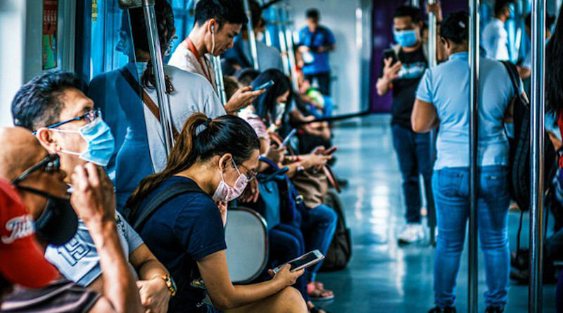 Filipinos wear masks while inside a commuter train in Manila, a day after President Rodrigo Duterte imposed a lockdown in the Philippine capital, March 13, 2020. Luis Liwanag/BenarNews