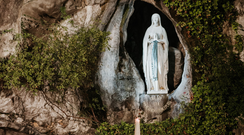 The statue of Our Lady of Lourdes in the grotto in the French shrine. Photo Credit: Kamil Szumotalski at Unsplash
