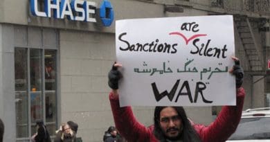 Protester's sign decries sanctions, "a silent war". Photo credit: Campaign for Peace and Democracy, 2013