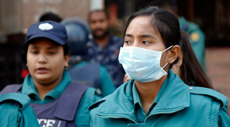 A Bangladeshi policewoman in Dhaka wears a mask to guard against the novel coronavirus. Photo Credit: BenarNews