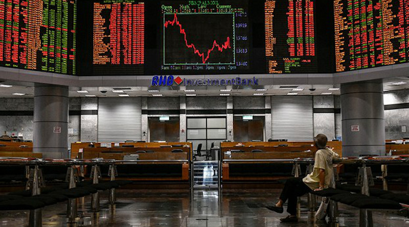 A man looks at the electronic screens at the Malaysian stock exchange Bursa Malaysia in Kuala Lumpur. Photo Credit: S. Mahfuz/BenarNews