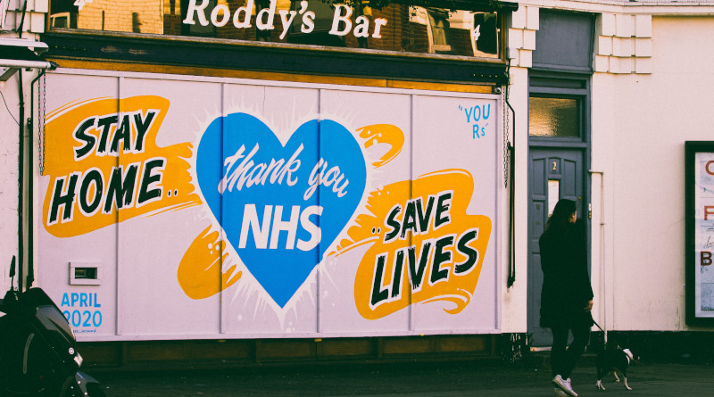 A woman walks past a street mural, during the lockdown in London 2020. Photo Credit: Edward Howell at Unsplash