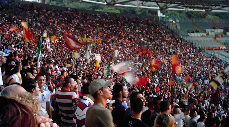 Roma football fans at the Stadio Olimpico. Photo Credit: kingpenguin1029, Wikipedia Commons