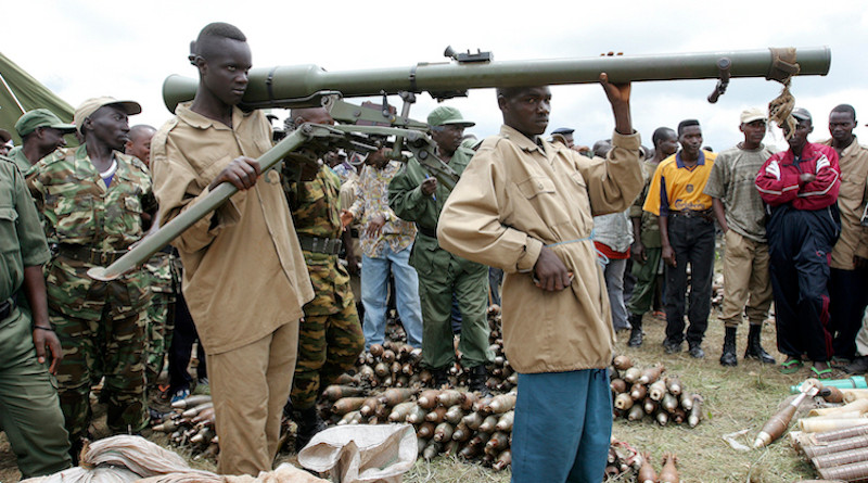 Members of CNDD-FDD rebel forces surrender their weapons and ammunition to United Nations Operation in Burundi (ONUB) peacekeepers in Mbanda, southern Burundi. 03 February 2005. UN Photo/Martine Perret.