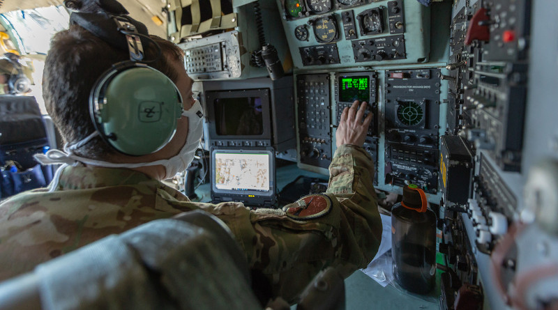 Air Force Lt. Col. Josh Linden, a C-130H Hercules navigator with the Connecticut Air National Guard’s 103rd Airlift Wing, programs the flight computer before takeoff. Flight computers such as the ones in C-130H aircraft are built with microelectronics, and the Defense Department must ensure those microelectronics are safe to use before they are installed in weapons systems. Photo Credit: Marine Corps Staff Sgt. Hector de Jesus