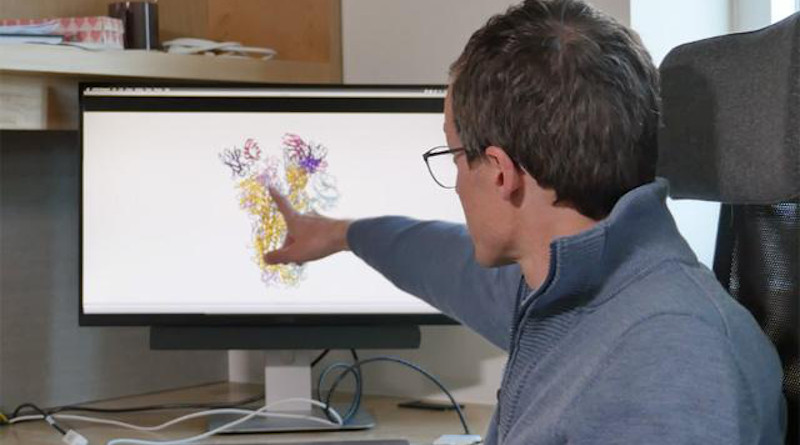 David Veesler, in his office at the University of Washington School of Medicine, explains how the newly identified neutralizing antibody against the SARS and COVID-19 coronaviruses works in the laboratory. CREDIT: UW Medicine