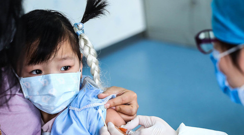 A three-year-old girl receives a vaccine shot at a community health centre in Beijing. Credit: UNICEF/Zhang Yuwei