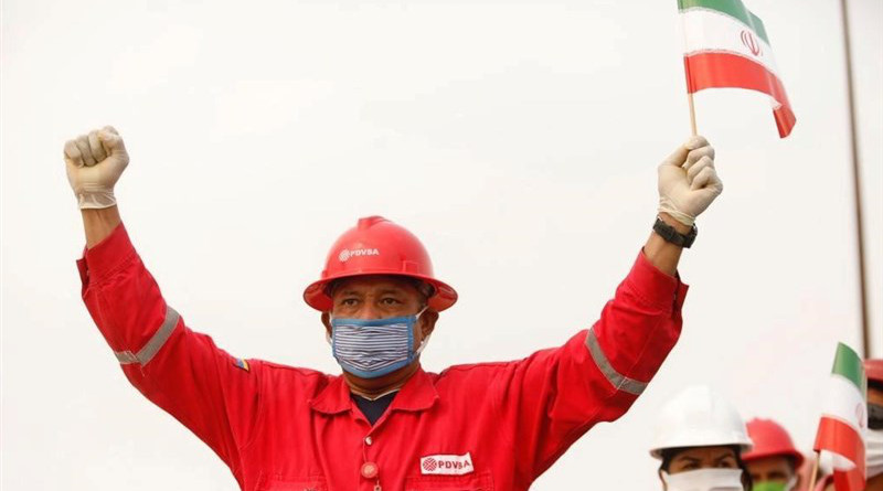 Workers for Venezuela's oil company PDVSA wave Iranian flags. Photo Credit: Tasnim News Agency