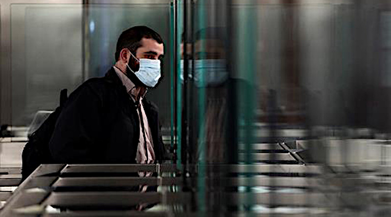 Man wearing mask prepares to ride in Spain's public transportation system. Photo Credit: Spanish government