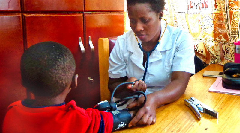 A nurse at Mulago Hospital in Kampala, Uganda, conducts a follow up medical check on a child who participated in a study testing hydroxyurea dosing in children with sickle cell anemia. Researchers say the study helps remove barriers to expanding the drug's use in low-resource settings like sub-Saharan Africa. CREDIT: IU School of Medicine