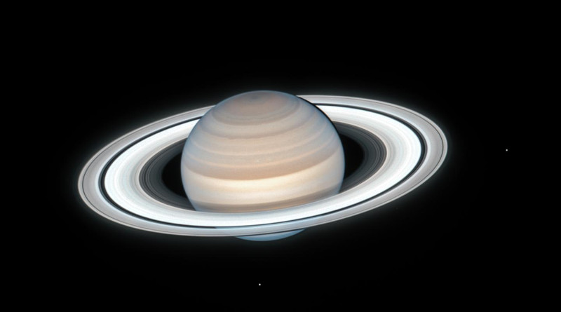 NASA's Hubble Space Telescope captured this image of Saturn on July 4, 2020. Two of Saturn's icy moons are clearly visible in this exposure: Mimas at right, and Enceladus at bottom. This image is taken as part of the Outer Planets Atmospheres Legacy (OPAL) project. OPAL is helping scientists understand the atmospheric dynamics and evolution of our solar system's gas giant planets. In Saturn's case, astronomers continue tracking shifting weather patterns and storms. CREDIT: NASA, ESA, A. Simon (Goddard Space Flight Center), M.H. Wong (University of California, Berkeley), and the OPAL Team
