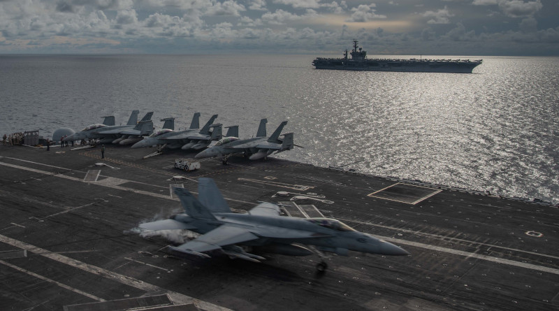 A fighter jet lands on the USS Ronald Reagan flight deck as the USS Nimitz sails nearby during drills in the South China Sea, July 6, 2020. U.S. Navy photo by Mass Communication Specialist 2nd Class Samantha Jetzer/Released