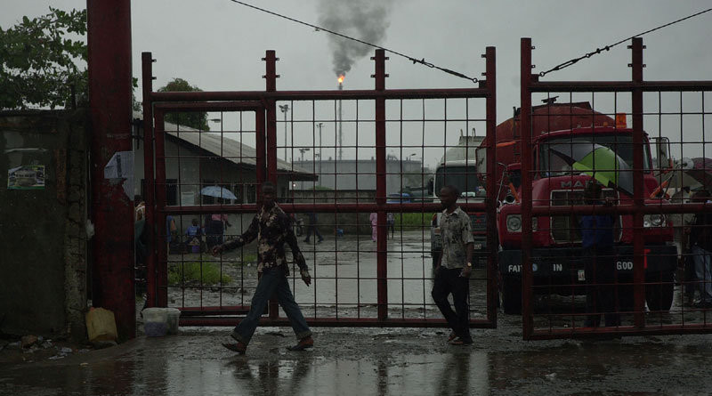 The gates of the oil refinery in Port Harcourt, Nigeria. Photo Credit: sixoone - Wish For Africa, Wikipedia Commons