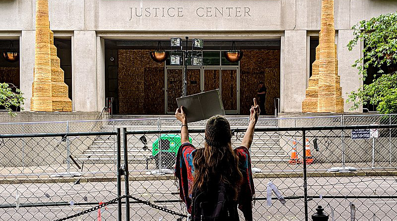 Daytime protester in front of the Multnomah County Justice Center in Portland, Oregon. Photo Credit: Ted Timmons, Wikipedia Commons