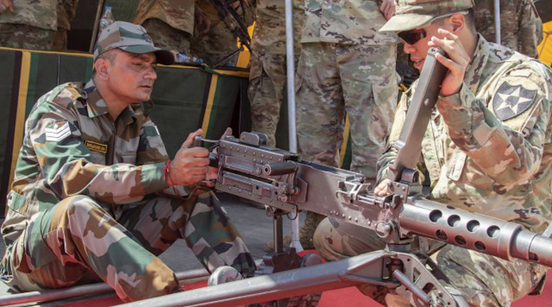Spc. Kellin Kirby, a team leader with 1st Battalion, 23rd Infantry Regiment, instructs an Indian army soldier on the use of the M2 50 Cal. Machine Gun during a weapons demonstration Sept. 18, 2018, at Chaubattia Military Station, India. (Photo Credit: U.S. Army)