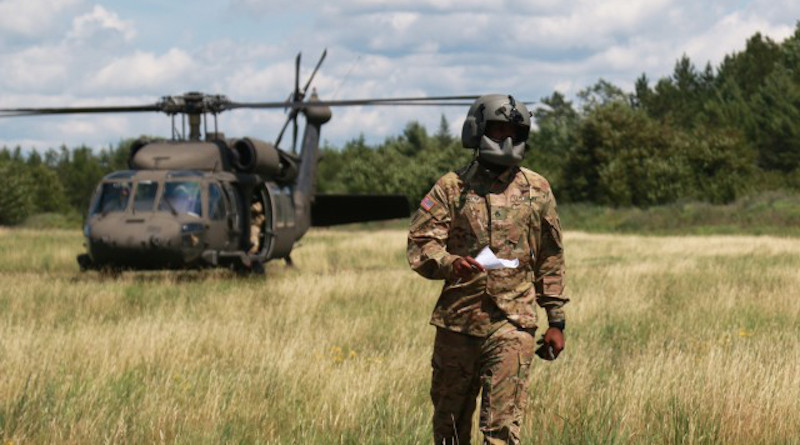 Staff Sgt. Christopher Abrom, a member of Charlie Company, 1st of the 158th Assault Helicopter Battalion prepares to certify a high mobility multipurpose wheeled vehicle (HMMWV) for sling load operations during Northern Strike 19 on Camp Grayling, Mich., July 21, 2019. (Photo Credit: Sgt. Priscilla Desormeaux)