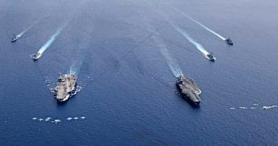 Planes from Carrier Wing 5 and Carrier Wing 17 fly in formation as the aircraft carriers USS Nimitz and USS Ronald Reagan, and other ships sail together in the South China Sea, July 6, 2020. Courtesy U.S. Navy