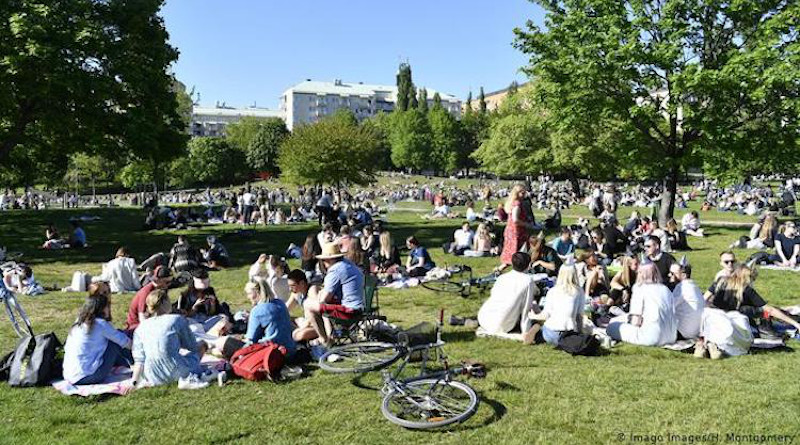 People in a park in Stockholm without observing social distancing. Images / H. Credit: Imago Images/H. Montgomery. Source: The Coversation.