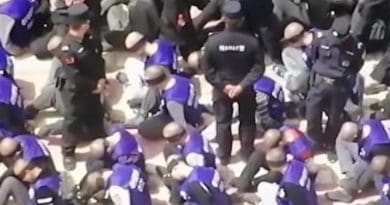 Drone video footage shows blindfolded and shackled Uyghur men in China’s far west in 2019. (Image: YouTube)