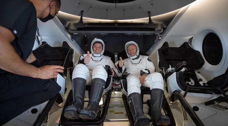 NASA astronauts Robert Behnken, left, and Douglas Hurley are seen inside the SpaceX Crew Dragon Endeavour spacecraft onboard the SpaceX GO Navigator recovery ship shortly after having landed in the Gulf of Mexico off the coast of Pensacola, Florida, Sunday, Aug. 2, 2020. The Demo-2 test flight for NASA's Commercial Crew Program was the first to deliver astronauts to the International Space Station and return them safely to Earth onboard a commercially built and operated spacecraft. Behnken and Hurley returned after spending 64 days in space. Image Credit: NASA/Bill Ingalls