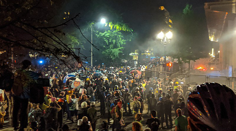 Tear gas and fires at Mark O. Hatfield United States Courthouse during the 2020 George Floyd protests in Portland, Oregon. Photo Credit: Tedder, Wikipedia Commons