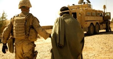Marine with Combined Anti-Armor Team 1, 1st Battalion, 5th Marine Regiment, escort enemy prisoner of war away for questioning after discovering illegal drugs and improvised explosive device–making material, Helmand Province, Afghanistan, October 19, 2009 (U.S. Marine Corps/John McCall)