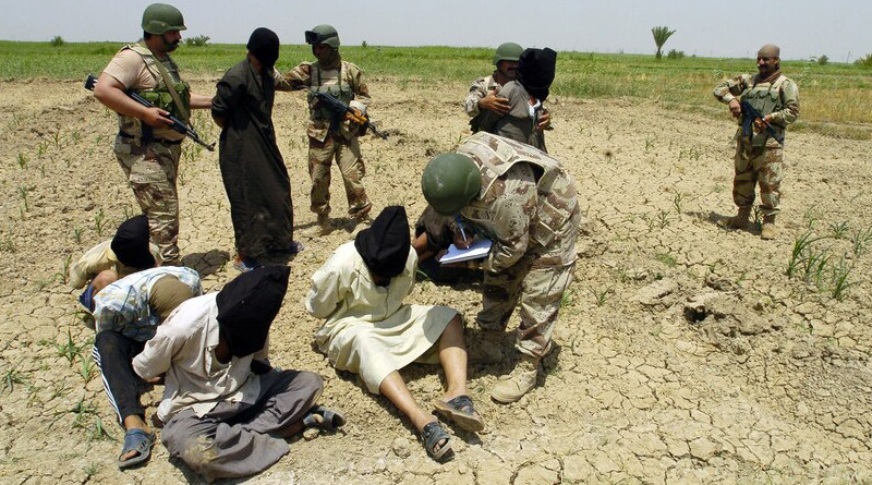 Iraqi soldiers from 3rd Brigade, 5th Iraqi army, question apprehended insurgents at detainee collection point during Operation Peninsula, in Wasit Provence, Iraq, May 20, 2005 (U.S. Army/Arthur Hamilton)