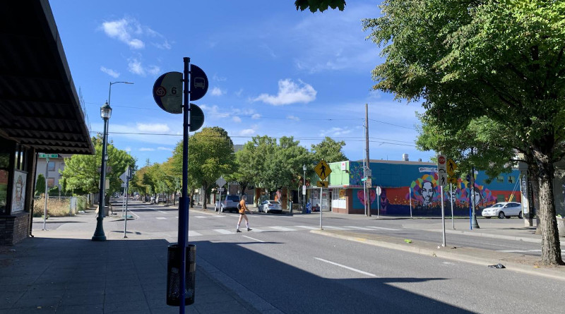 View of North MLK Boulevard in Portland, Oregon with a pedestrian crossing near a mural. CREDIT: Photo by Cait McCusker