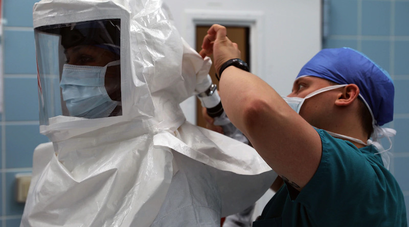 Army Maj. (Dr.) Neel Shah, an anesthesiologist, gets assistance with putting on a powered, air-purifying respirator at Landstuhl Regional Medical Center in Landstuhl, Germany, Aug. 7, 2020. Photo Credit: Russell Toof, Army