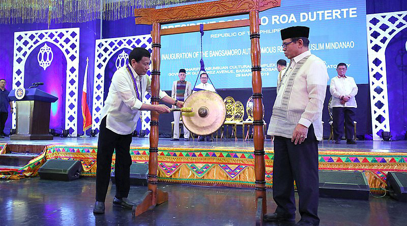 Philippines' President Rodrigo Duterte sounds the agong during the inauguration of Bangsamoro. He is joined by Chief Minister Murad Ebrahim. Photo Credit: Robinson Ninal Jr. for the Presidential Communications Operations Office