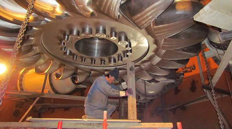 A worker installs a turbine at the Moynak hydropower plant in Kazakhstan’s east. (Moynak GES handout)