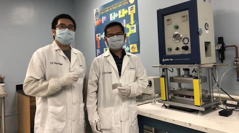Haodong Liu and Professor Ping Liu hold batteries made with the disordered rocksalt anode material they discovered, standing in front of a device used to fabricate battery pouch cells. CREDIT: Ping Liu lab