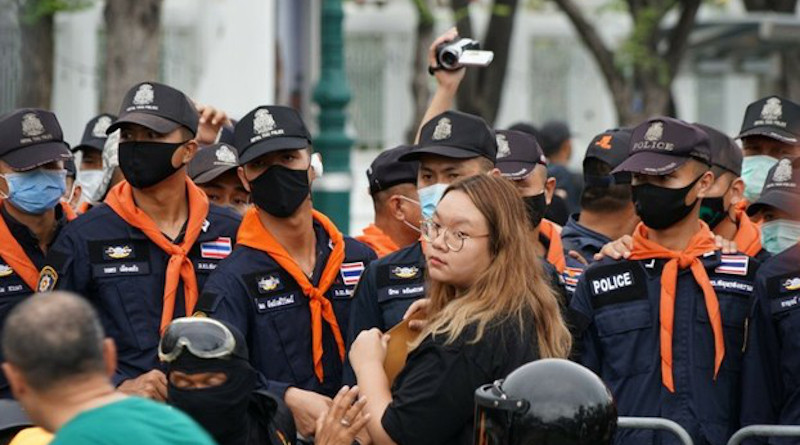 Protest leader Panusaya Sithijirawattankul stands in front of a police barrier as she holds a letter addressed to Thailand’s king asking him to support political reforms, Sept. 20, 2020. Photo Credit: Nontarat Phaicharoen/BenarNews