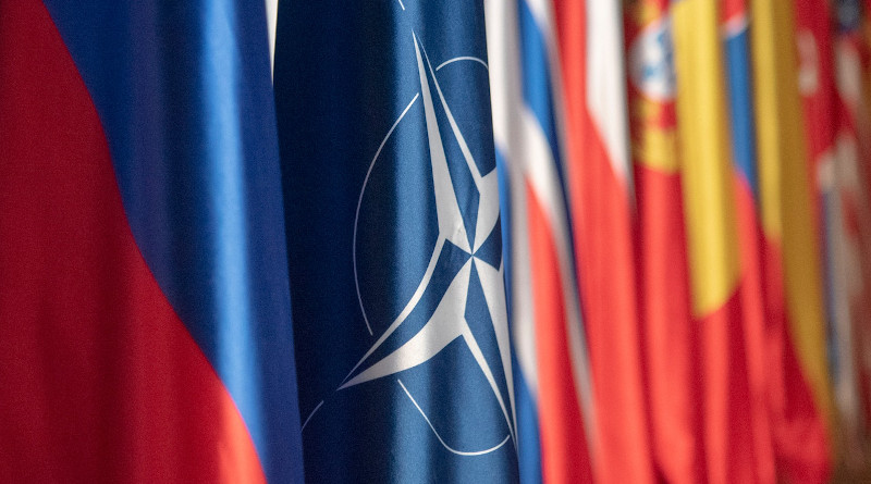 The NATO flag hangs in the plenary room at the NATO Military Committee Conference in Ljubljana, Slovenia. Photo Credit: Navy Petty Officer 1st Class Dominique A. Pineiro, DOD