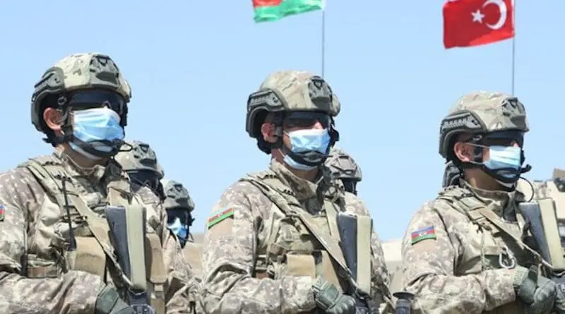 Azerbaijan soldiers with flags of Turkey and Azerbaijan in background. Photo Credit: Fars News Agency