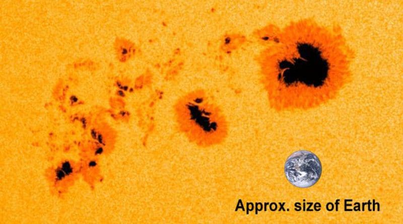 One of the largest sunspots seen in early January 2014, as captured by NASA's Solar Dynamics Observatory. An image of Earth has been added for scale. CREDIT: NASA/SDO