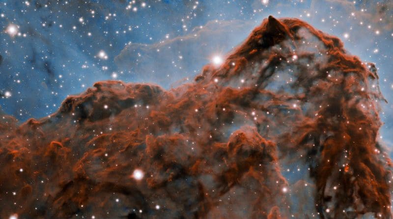 A 50-trillion-km (33-trillion-mile, or 5 light-year) long section of the western wall in the Carina Nebula, as observed with adaptive optics on the Gemini South telescope. This mountainous section of the nebula reveals a number of unusual structures including a long series of parallel ridges that could be produced by a magnetic field, a remarkable almost perfectly smooth wave, and fragments that appear to be in the process of being sheared off the cloud by a strong wind. There is also evidence for a jet of material ejected from a newly-formed star. The exquisite detail seen in the image is in part due to a technology known as adaptive optics, which resulted in a ten-fold improvement in the resolution of the research team's observations. CREDIT International Gemini Observatory/NOIRLab/NSF/AURA Acknowledgment: PI: Patrick Hartigan (Rice University) Image processing: Patrick Hartigan (Rice University), Travis Rector (University of Alaska Anchorage), Mahdi Zamani & Davide de Martin