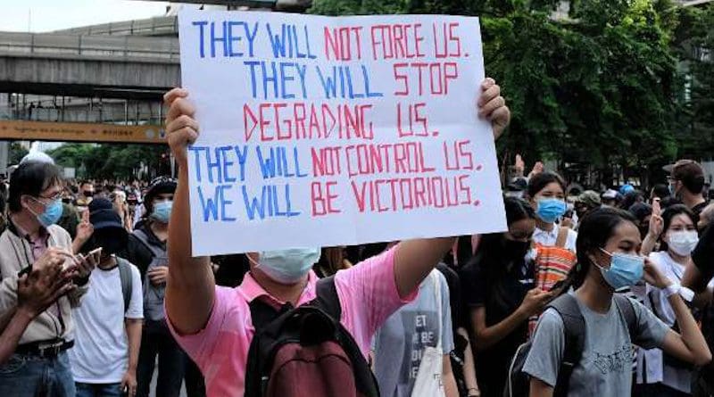 A young Thai protester holds up a sign at a mass rally against the military-led government at a key intersection in Bangkok's commercial heart on Oct. 15. (Photo: UCA News)