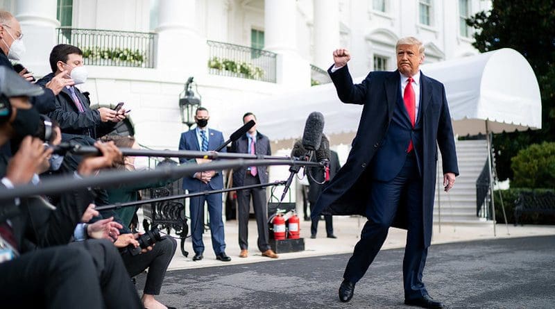 President Donald J. Trump gives a fist bump to the press Friday, Oct. 30, 2020, prior to boarding Marine One en route to Joint Base Andrews, Md. to begin his trip to Michigan, Wisconsin and Minnesota. (Official White House Photo by Tia Dufour)