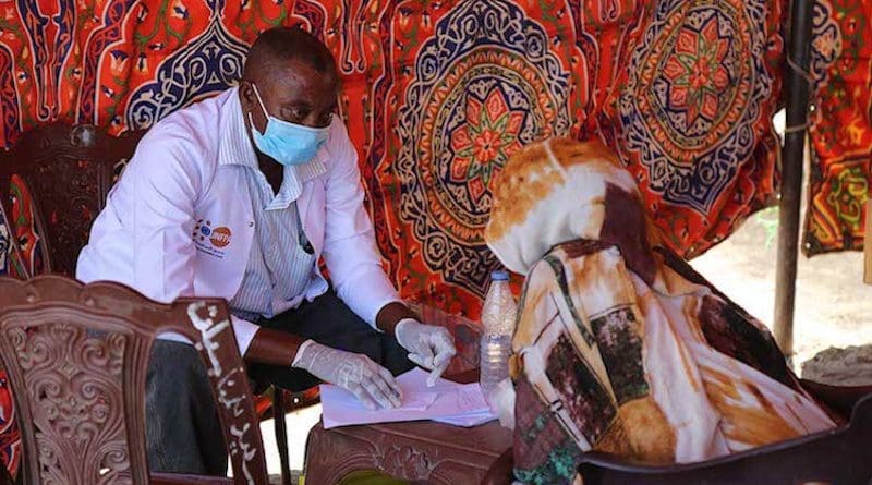A woman receives health services at a transit point in Hamdayet. Credit: UNFPA Sudan/Sufian Abdul-Mouty.