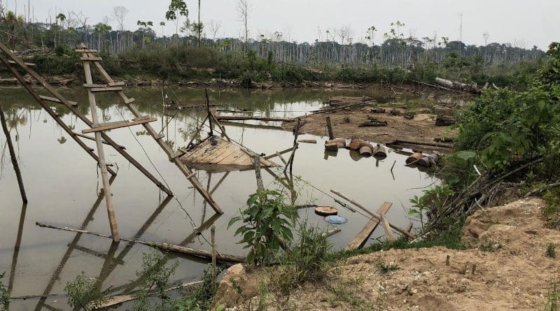 Thousands of artificial ponds like this one, created when rainwater filled in an abandoned gold mining pit, are amplifying risks of mercury exposure for humans and wildlife in the Peruvian Amazon. CREDIT: Melissa Marchese