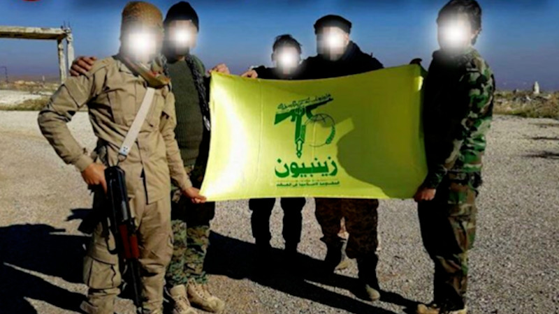Undated photo of Pakistani members of Zainebiyoun Brigade holding their flag in Syria. Photo Credit: Social media