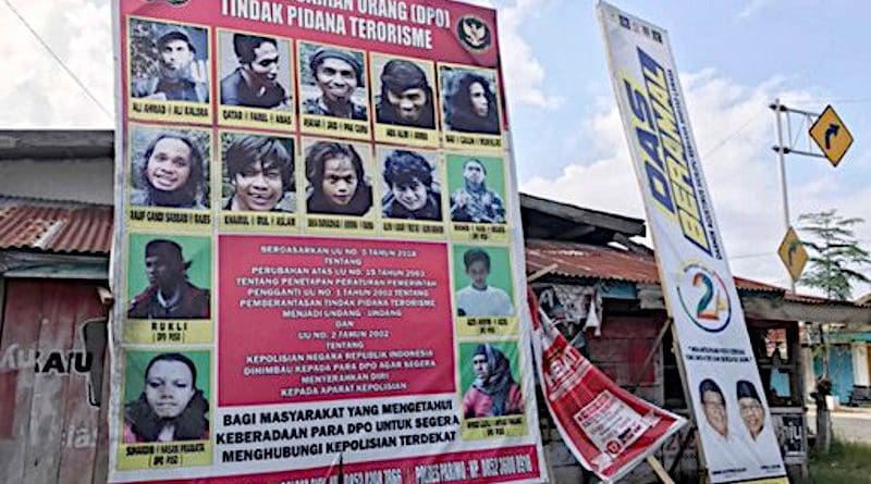 A billboard shows photographs of suspected MIT militants wanted by the authorities, in Poso regency, Indonesia, Nov. 20, 2020. [Keisyah Aprilia/BenarNews]