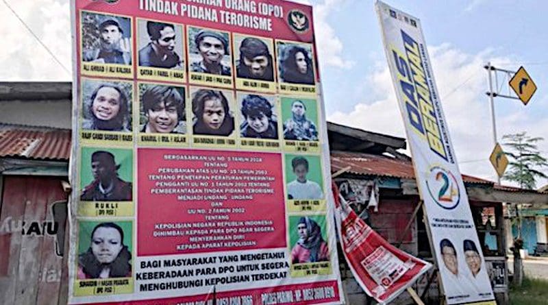 A billboard shows photographs of suspected MIT militants wanted by the authorities, in Poso regency, Indonesia, Nov. 20, 2020. [Keisyah Aprilia/BenarNews]