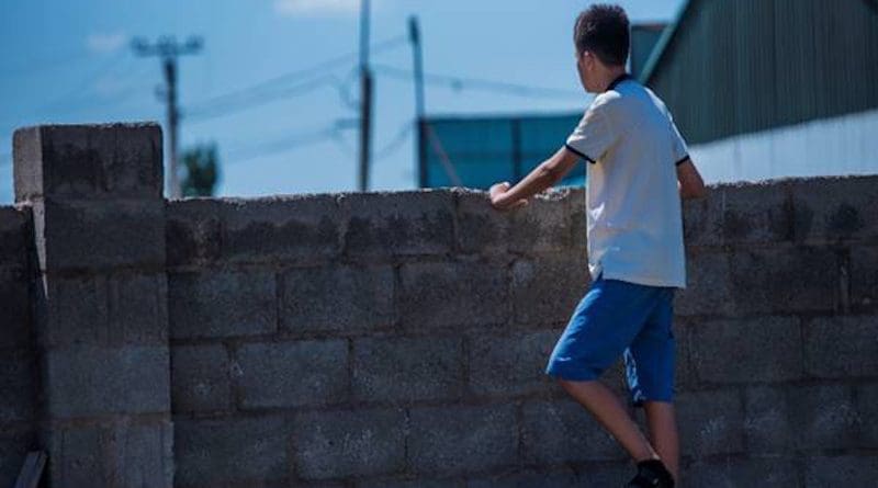 Photo credit: UNICEF/Kadyrbekov asia migrant man barrier wall boy