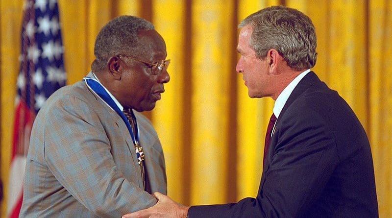 Hank Aaron accepting the Presidential Medal of Freedom from US President George W. Bush in 2002. Photo Credit: Records of the White House Photo Office (George W. Bush Administration)