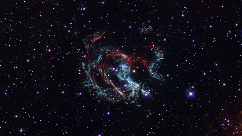 This Hubble Space Telescope portrait reveals the gaseous remains of an exploded massive star that erupted approximately 1,700 years ago. The stellar corpse, a supernova remnant named 1E 0102.2-7219, met its demise in the Small Magellanic Cloud, a satellite galaxy of our Milky Way. CREDIT Credits: NASA, ESA, and J. Banovetz and D. Milisavljevic (Purdue University)