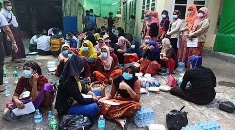 Rohingya Muslims sit on the ground during a police raid on two houses where they were staying while en route to Malaysia, in Shwepyitha township, Myanmar's Yangon region, Jan. 6, 2021. Photo courtesy of Yangon Region Police Force