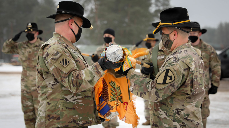 2nd Battalion, 8th Cavalry Regiment, 1st Armored Brigade Combat Team, 1st Cavalry Division Commander Lt. Col. Steven E. Jackowski and Command Sgt. Maj. Jesus Pena carefully unfurl the battalion’s colors Jan. 4, 2021. The small, socially distanced ceremony officially signified the arrival of the battalion to the Pabrade Training Area, Lithuania. (Photo Credit: Sgt. Alexandra Shea)